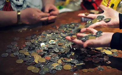 Canadian coins in two hands